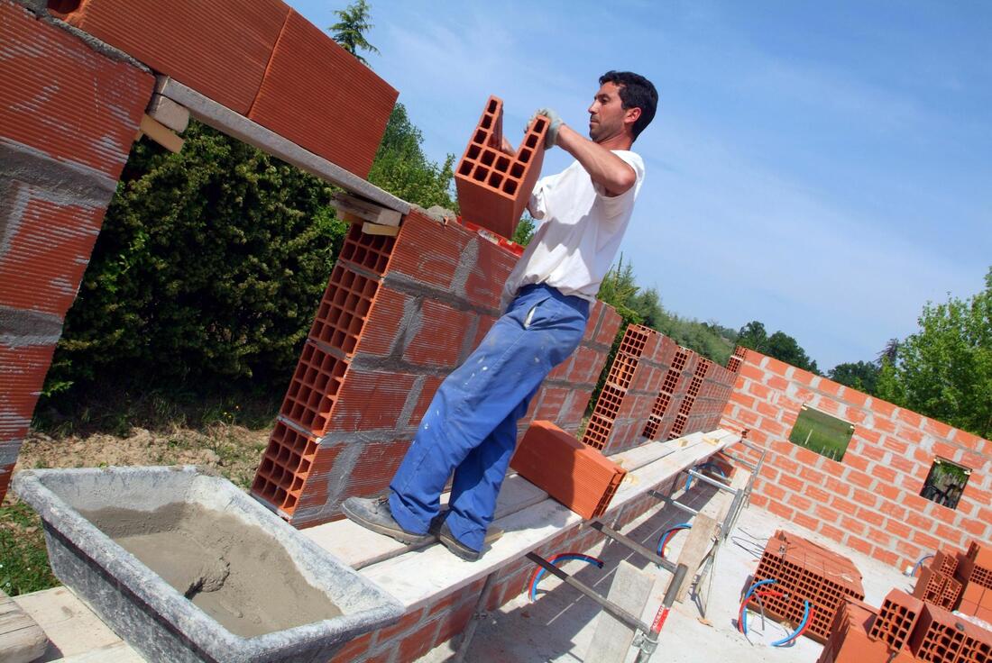 man doing a brick wall