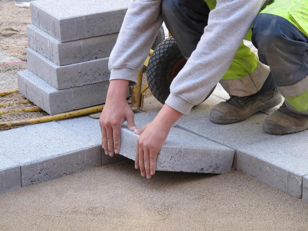 man installing concrete blocks